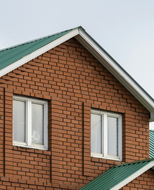 Red brick house with green roof. Traditional european cultures architecture. Red brick house with green roof. Traditional european cultures architecture.